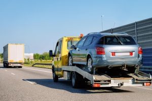 tow-truck-transporter-carrying-car-road-slovenia_250132-26269